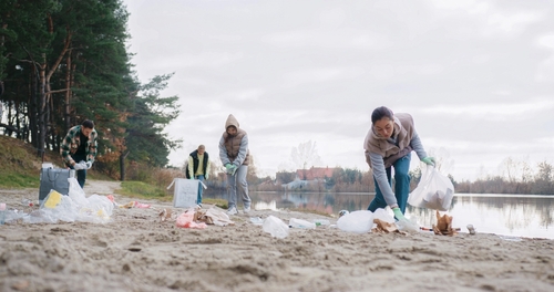 People cleaning up plastic on a beach